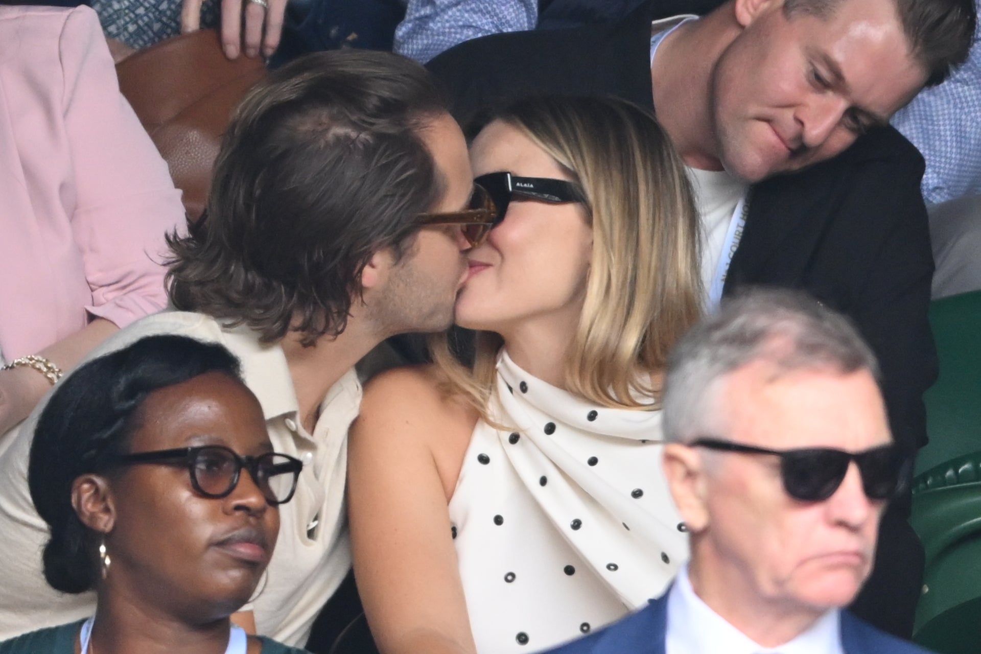 Ms Robbie shared a kiss with her husband in the Wimbledon crowd