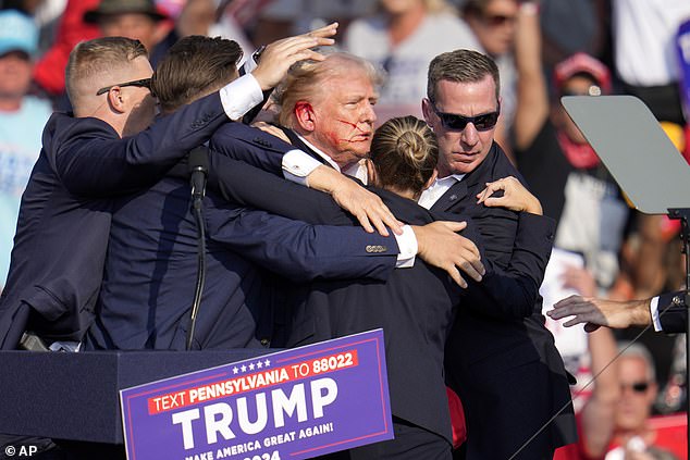 Republican presidential candidate former President Donald Trump is helped off the stage at a campaign event in Butler, Pa.