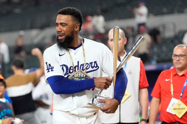 Dodgers outfielder Teoscar Hernández holds the Home Run Derby trophy...