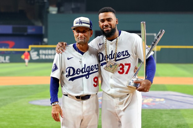 Dodgers outfielder Teoscar Hernández, right, celebrates with Dodgers third base...