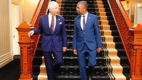 PA Media The King and Vaughan Gething walking downstairs at the Mansion House in Cardiff 