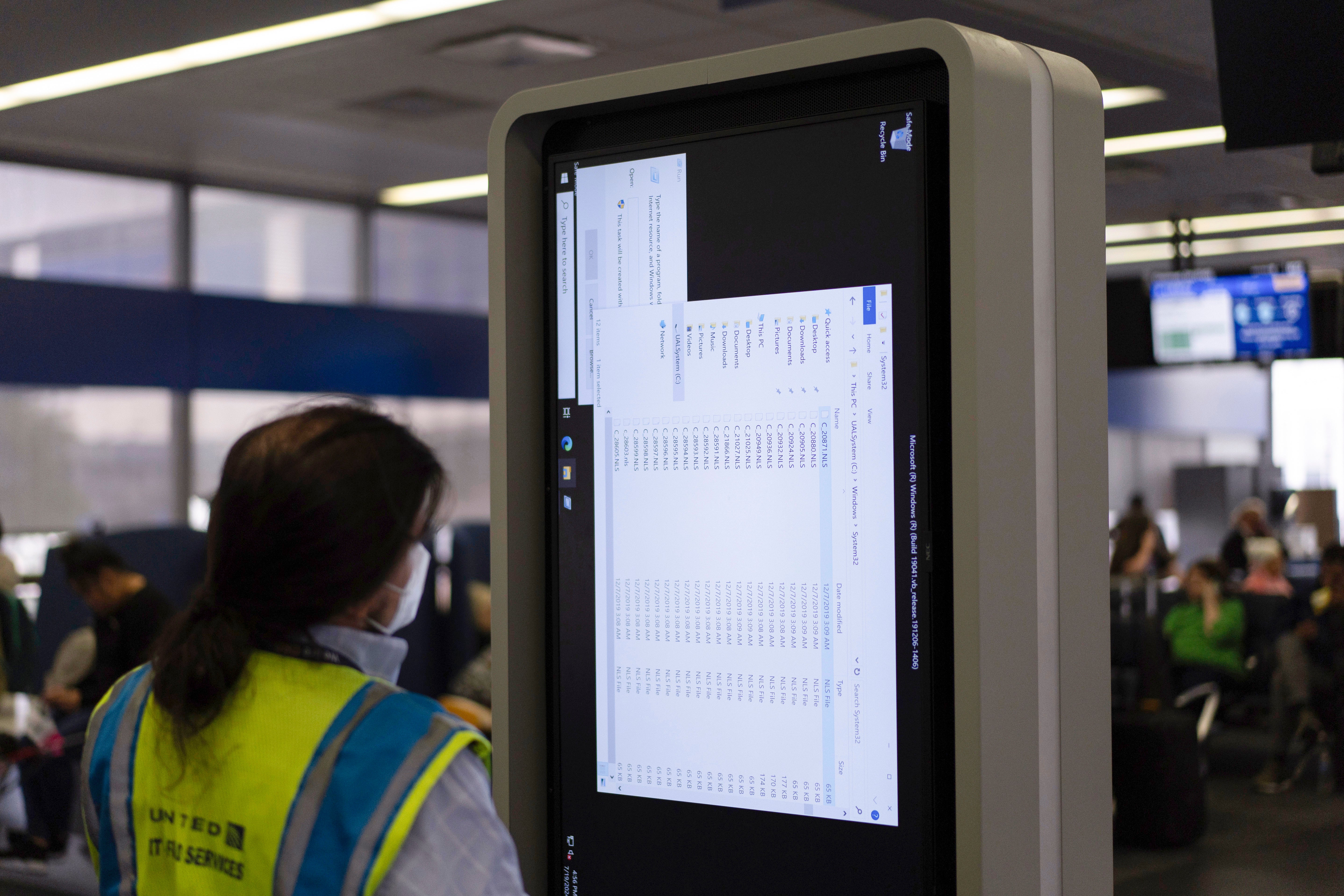 A technician works on an information display after a faulty CrowdStrike update caused a major internet outage for computers running Microsoft Windows