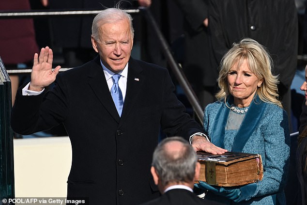 Joe Biden and Dr Jill Biden are pictured together as he is sworn in as the 46th US President by Supreme Court Chief Justice John Roberts on January 20, 2021