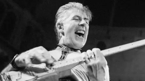 Getty Images John Mayall looking excited while playing guitar