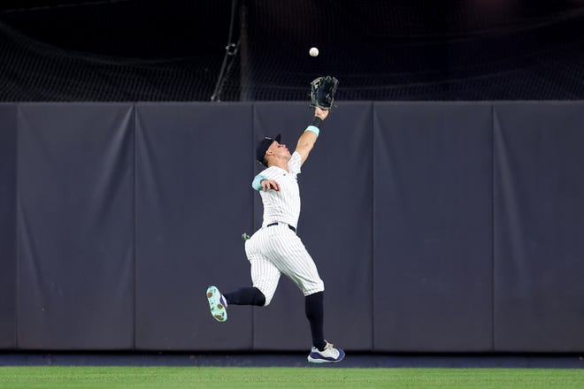 Jul 24, 2024; Bronx, New York, USA; New York Yankees center fielder Aaron Judge (99) reaches for but cannot catch a double by New York Mets right fielder Jeff McNeil (not pictured) during the eighth inning at Yankee Stadium. Mandatory Credit: Brad Penner-USA TODAY Sports