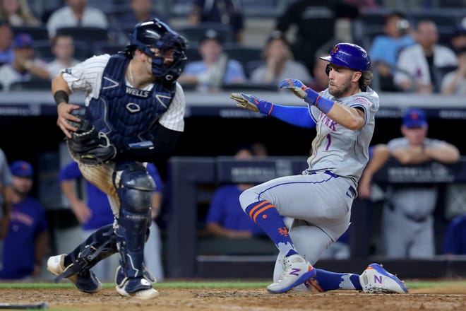 Jul 24, 2024; Bronx, New York, USA; New York Mets right fielder Jeff McNeil (1) scores against New York Yankees catcher Austin Wells (28) on a fielder's choice ground ball by Mets center fielder Tyrone Taylor (not pictured) during the eighth inning at Yankee Stadium. Mandatory Credit: Brad Penner-USA TODAY Sports