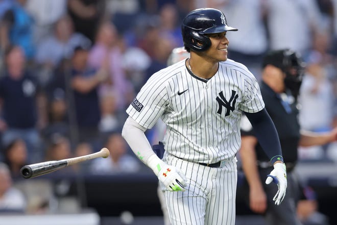 Jul 24, 2024; Bronx, New York, USA; New York Yankees right fielder Juan Soto (22) flips his bat after hitting a solo home run against the New York Mets during the third inning at Yankee Stadium. Mandatory Credit: Brad Penner-USA TODAY Sports