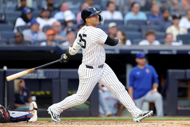 Jul 23, 2024; Bronx, New York, USA; New York Yankees second baseman Gleyber Torres (25) follows through on a solo home run during the second inning against the New York Mets at Yankee Stadium. Mandatory Credit: Brad Penner-USA TODAY Sports
