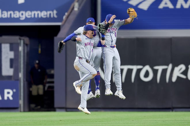 Jul 23, 2024; Bronx, New York, USA; New York Mets left fielder Brandon Nimmo (9) and center fielder Harrison Bader (44) and right fielder Tyrone Taylor (15) celebrate after defeating the New York Yankees at Yankee Stadium. Mandatory Credit: Brad Penner-USA TODAY Sports