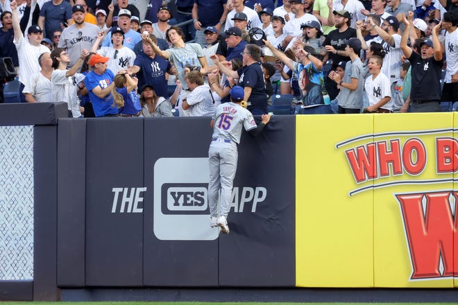 Jul 23, 2024; Bronx, New York, USA; New York Mets right fielder Tyrone Taylor (15) leaps but cannot catch a solo home run by New York Yankees second baseman Gleyber Torres (not pictured) during the second inning at Yankee Stadium. Mandatory Credit: Brad Penner-USA TODAY Sports