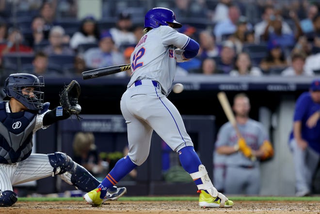 Jul 23, 2024; Bronx, New York, USA; New York Mets shortstop Francisco Lindor (12) is hit by a pitch with the bases loaded to drive in a run during the fifth inning against the New York Yankees at Yankee Stadium. Mandatory Credit: Brad Penner-USA TODAY Sports