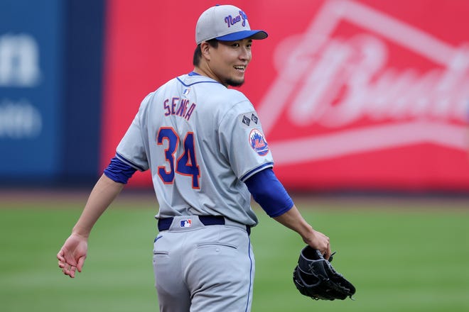 Jul 23, 2024; Bronx, New York, USA; New York Mets injured starting pitcher Kodai Senga (34) walks to the outfield at Yankee Stadium to work out before a game against the New York Yankees. Mandatory Credit: Brad Penner-USA TODAY Sports