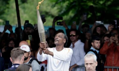 Snoop Dogg adds sizzle to Paris drizzle by carrying Olympic torch ahead of opening ceremony