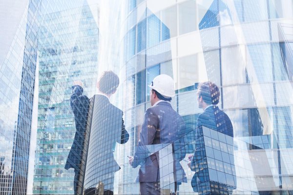 People looking up at office buildings.