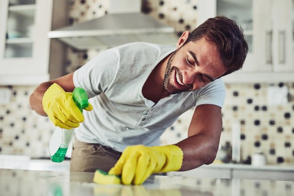 Person cleaning kitchen counter.