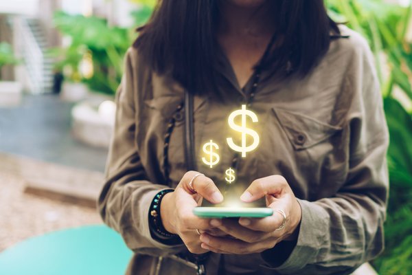 A person using their phone to send or receive money.