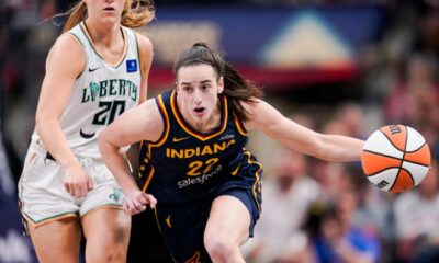 Indiana Fever guard Caitlin Clark (22) rushes up the court past New York Liberty guard Sabrina Ionescu (20) on Thursday, May 16, 2024, during the Indiana Fever home opener game against the New York Liberty at Gainbridge Fieldhouse in Indianapolis.