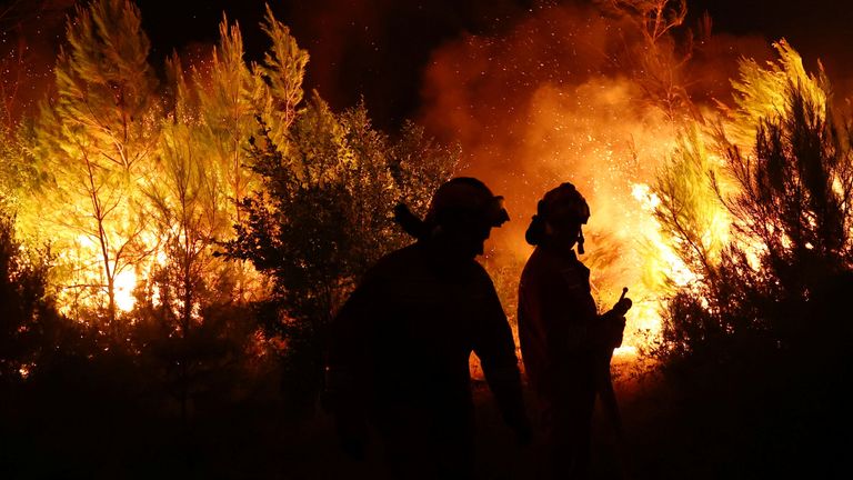 Members of emergency services work to contain a wildfire in Shengjin, Albania.
Pic: Reuters
