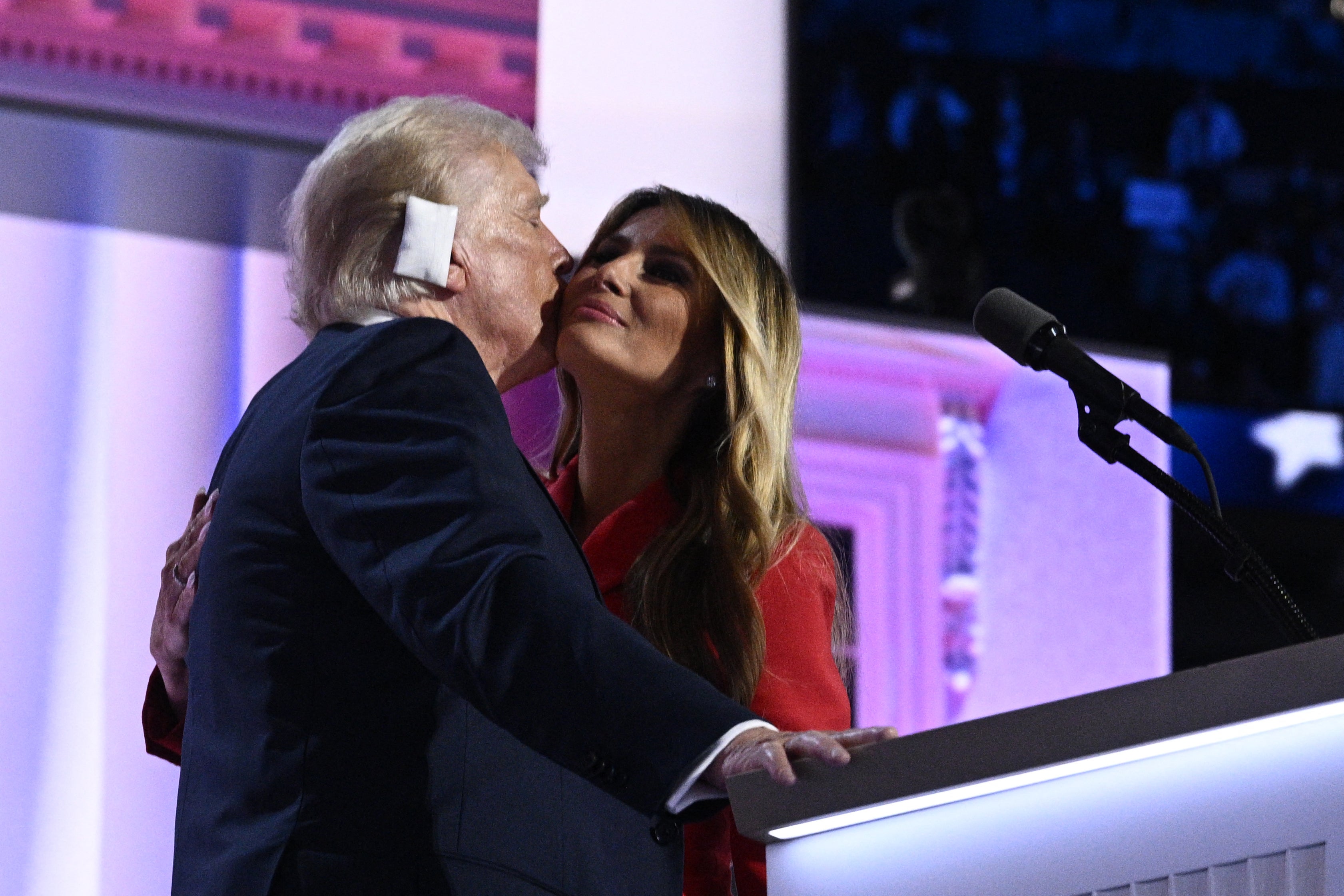 Former First Lady Melania Trump kisses US former president and 2024 Republican candidate Donald Trump as she joins him onstage on the last day of the 2024 Republican National Convention