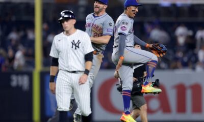 Jul 24, 2024; Bronx, New York, USA; New York Mets first baseman Pete Alonso (20) and third baseman Mark Vientos (27) celebrate after defeating the New York Yankees as Yankees first baseman Ben Rice (93) walks off the field after their game at Yankee Stadium. Mandatory Credit: Brad Penner-USA TODAY Sports