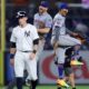 Jul 24, 2024; Bronx, New York, USA; New York Mets first baseman Pete Alonso (20) and third baseman Mark Vientos (27) celebrate after defeating the New York Yankees as Yankees first baseman Ben Rice (93) walks off the field after their game at Yankee Stadium. Mandatory Credit: Brad Penner-USA TODAY Sports