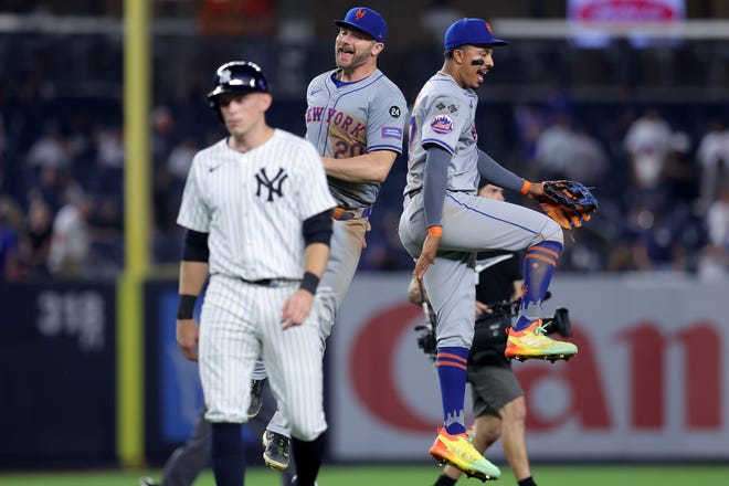Jul 24, 2024; Bronx, New York, USA; New York Mets first baseman Pete Alonso (20) and third baseman Mark Vientos (27) celebrate after defeating the New York Yankees as Yankees first baseman Ben Rice (93) walks off the field after their game at Yankee Stadium. Mandatory Credit: Brad Penner-USA TODAY Sports