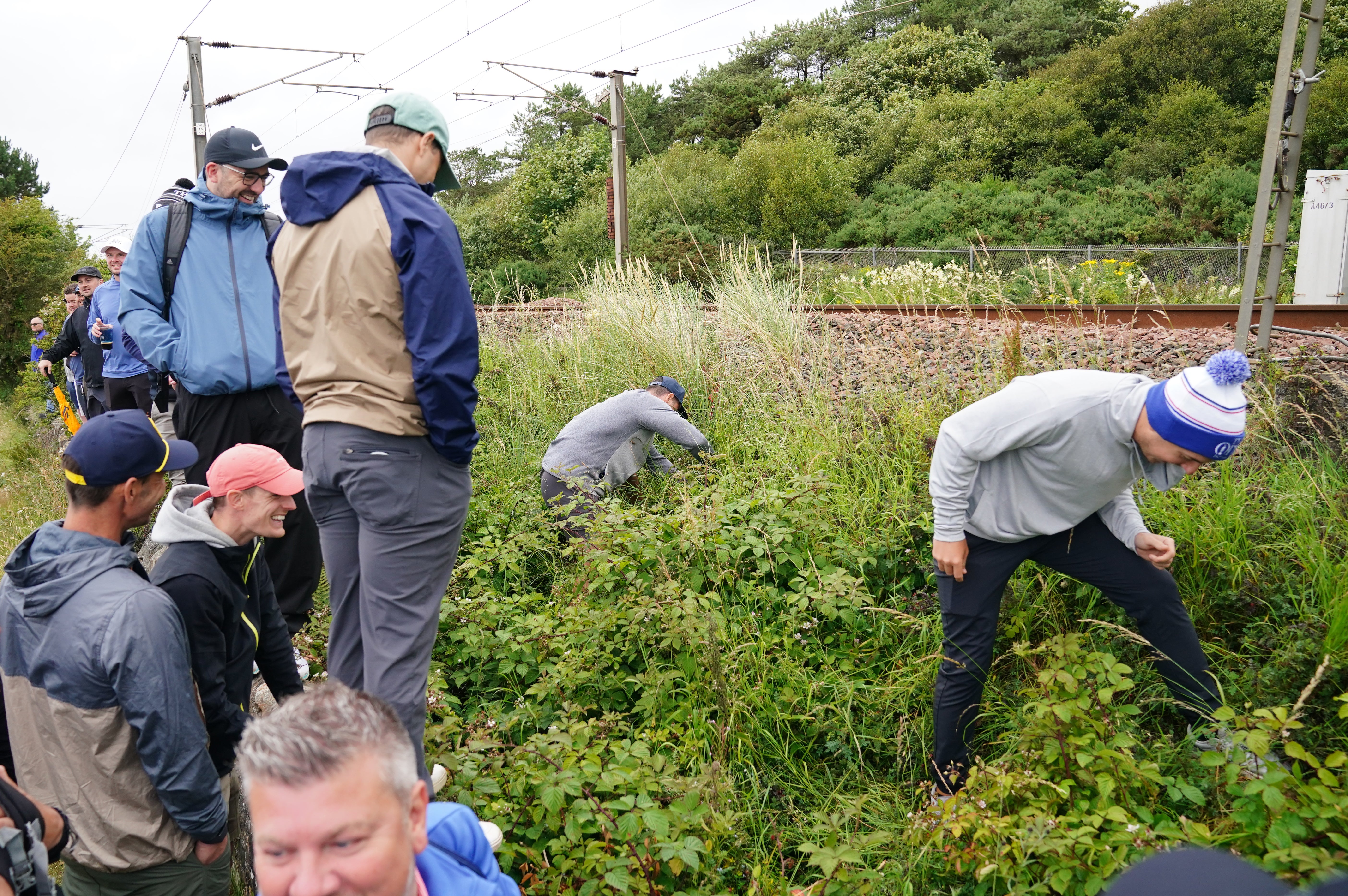 Spectators searched for Rory McIlroy’s ball, which went out of bounds on the 11th during day one of The 152nd Open at Royal Troon (Jane Barlow/PA)