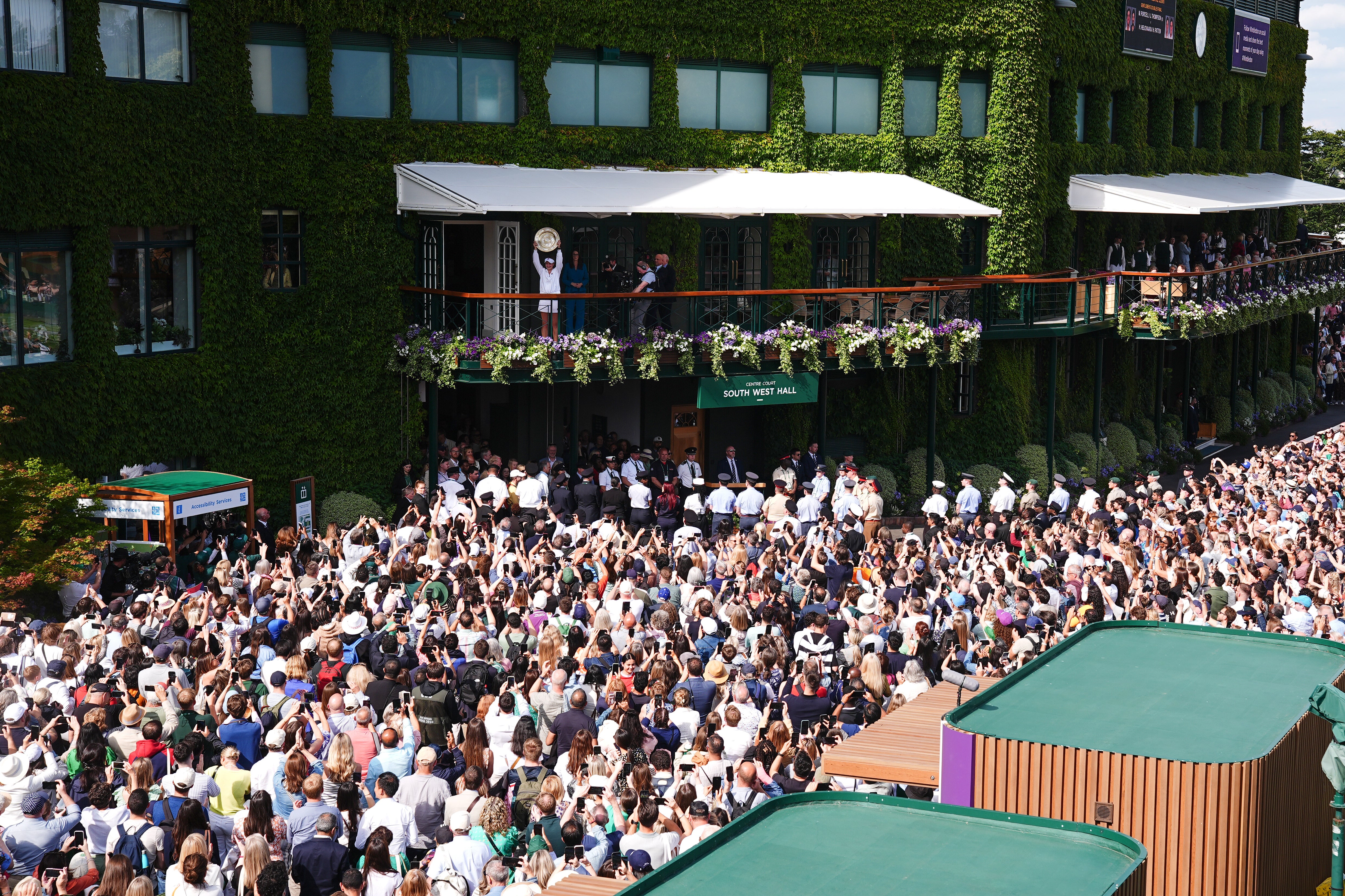 Barbora Krejcikova shows the Venus Rosewater Dish to the crowd (Aaron Chown/PA)