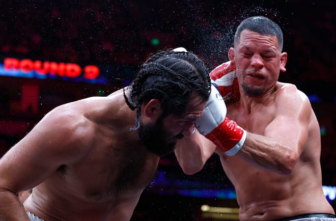 Jorge Masvidal, left, and Nate Diaz fight during the ninth round.