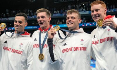 Britain's men's 4x200-meter freestyle relay team pose with their gold medals at the 2024 Summer Olympics, Tuesday, July 30, 2024, in Nanterre, France. (AP Photo/Matthias Schrader)