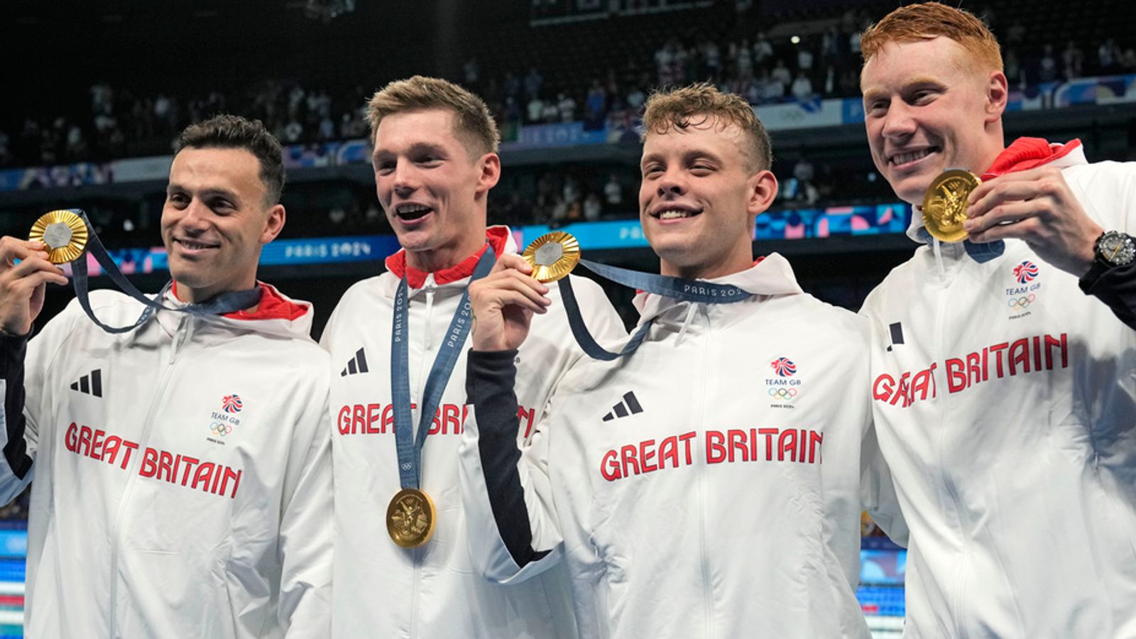 Britain's men's 4x200-meter freestyle relay team pose with their gold medals at the 2024 Summer Olympics, Tuesday, July 30, 2024, in Nanterre, France. (AP Photo/Matthias Schrader)