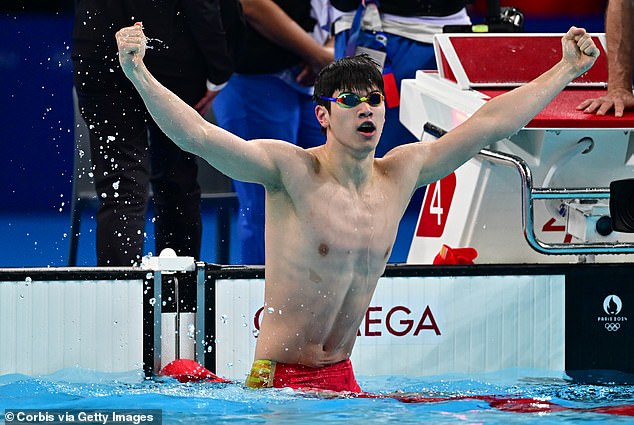 Zhanle celebrates after winning gold in a world record time in the Men's 100m Freestyle