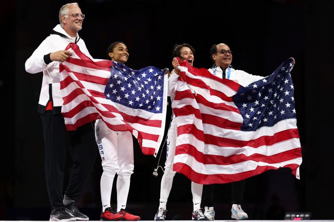 US fencers Lauren Scruggs, center left, and Lee Kiefer celebrate after facing off in the foil final on July 28. Kiefer overwhelmed Scruggs 15-6 to win the event for the second straight Olympics.