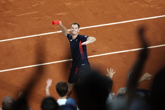 British tennis player Andy Murray throws his sweatband into the crowd after he and doubles partner Dan Evans advanced to the quarterfinals with a dramatic win over Belgium's Sander Gille and Joran Vliegen on July 30. Murray and Evans won 6-3, 6-7, 11-9. Murray has said this tournament will be the last of his legendary career.