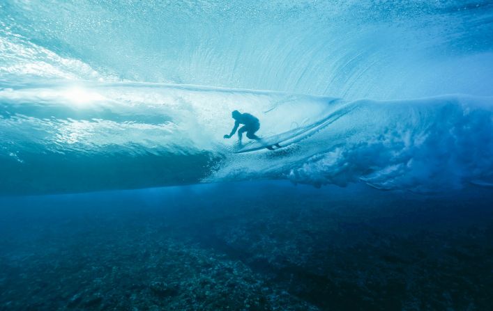 France's Joan Duru gets into the barrel during the first round of the surfing competition on July 27. The surfing events are taking place in Tahiti, far away from Paris.