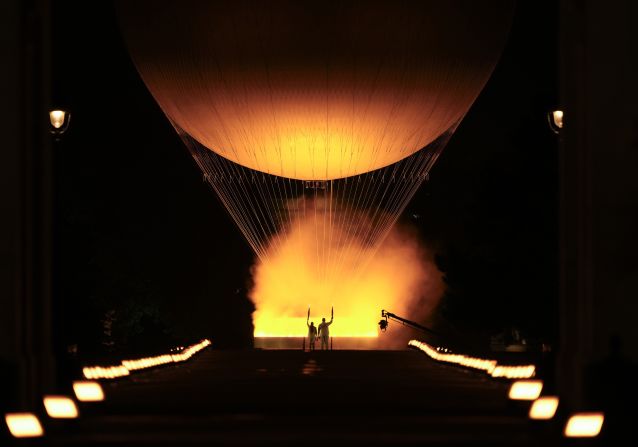 French judoka Teddy Riner, right, and former French track star Marie-José Pérec watch the Olympic cauldron rise in a hot-air balloon after they lit it at the end of the opening ceremony in Paris on Friday, July 26. The first hot-air balloon flight was performed in France in 1783.