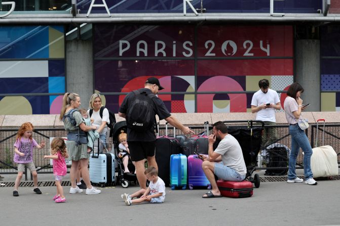 Travellers from Sydney wait outside the Gare Montparnasse train station on July 26. Just hours before the opening ceremony, France’s high-speed train lines were targeted by several “malicious” acts, including arson, in what has been described as “coordinated sabotage” to disrupt travel ahead of the Games.