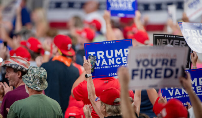 Attendees hold up campaign signs during a Donald Trump rally in the New Holland Arena at the Pennsylvania Farm Show complex in Harrisburg Wednesday, July 31, 2024.