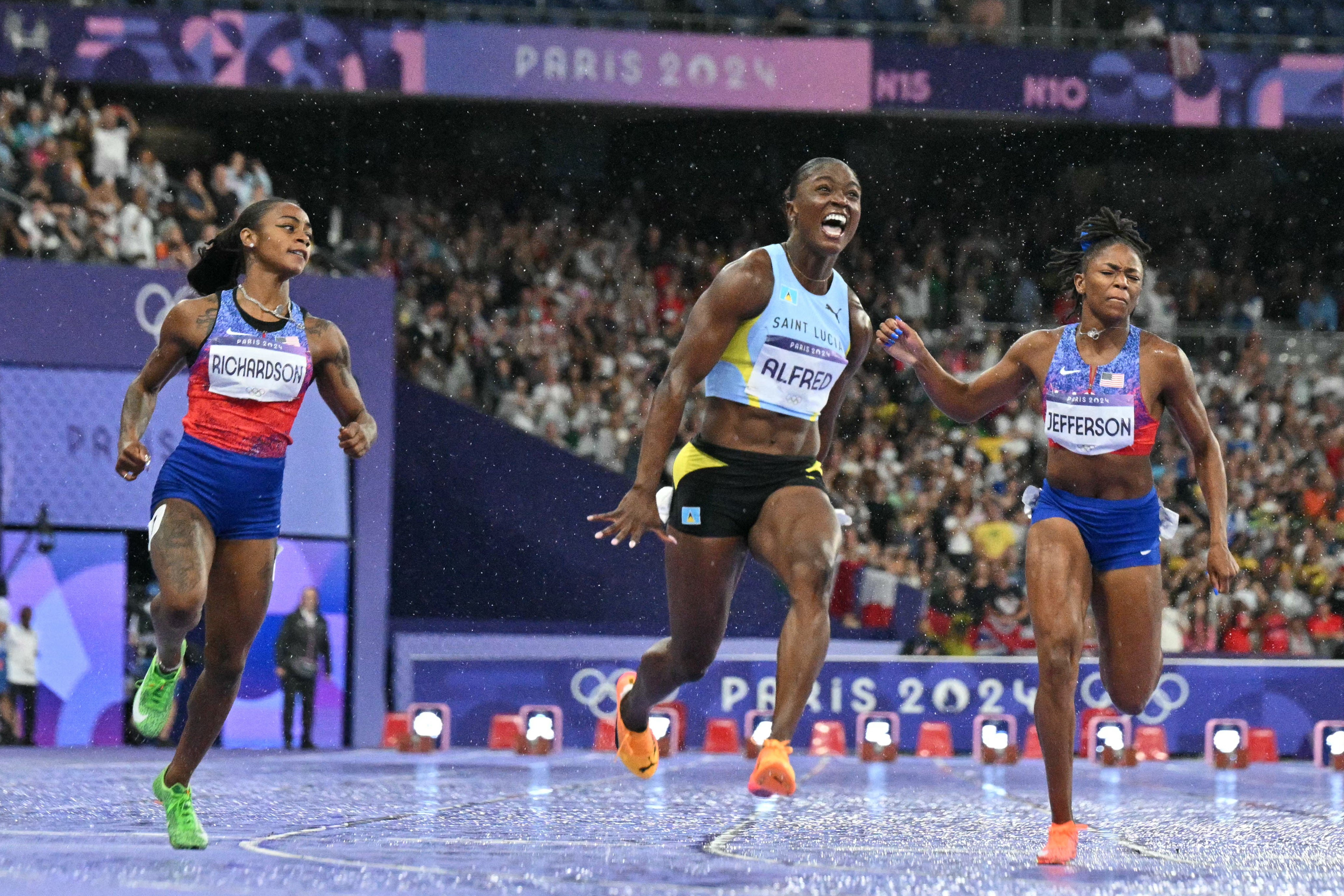 Julien Alfred crosses the line to clinch Olympic gold in the women’s 100 meters at the Paris Games