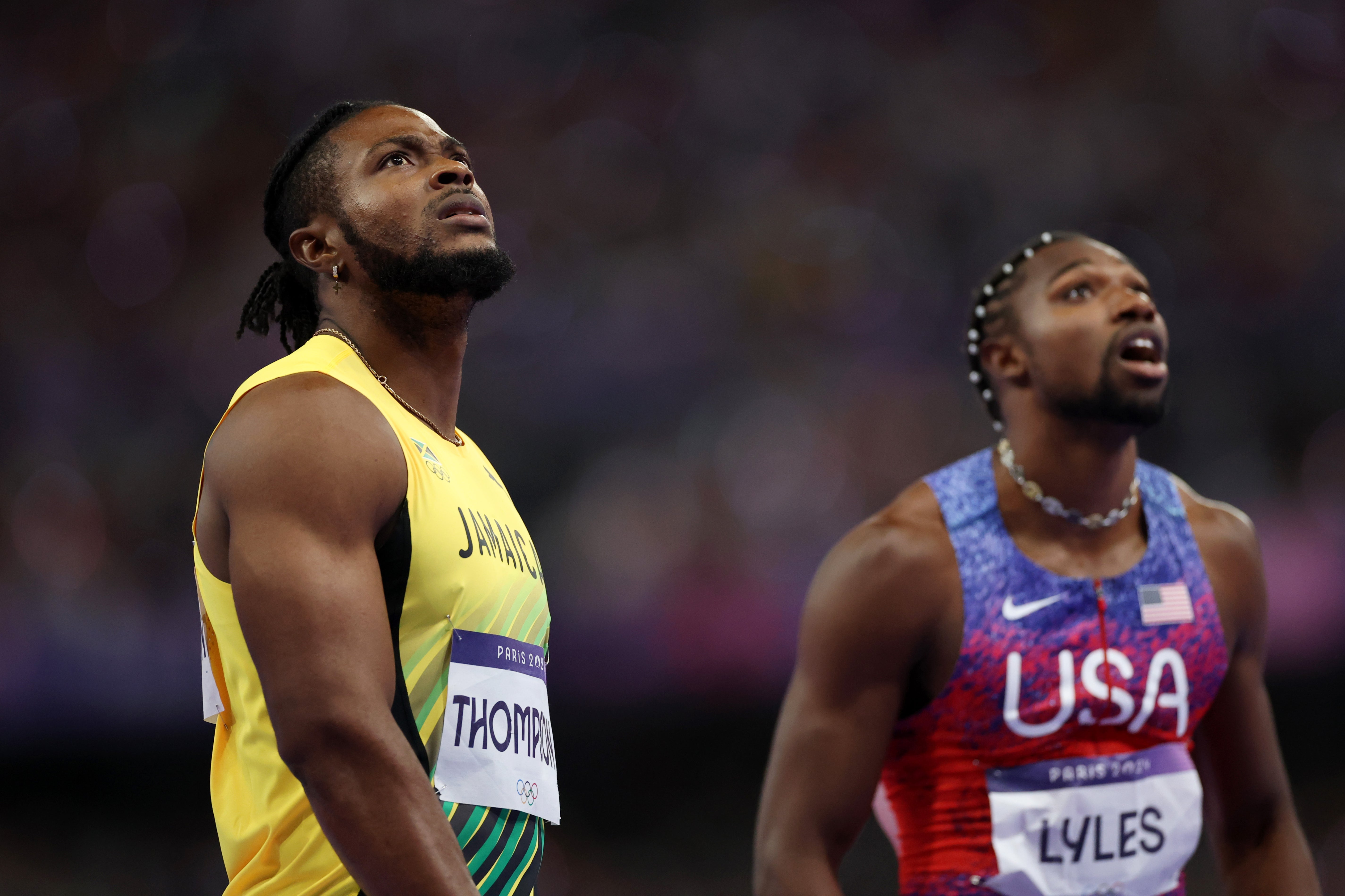 Thompson and Lyles stare up at the giant screen