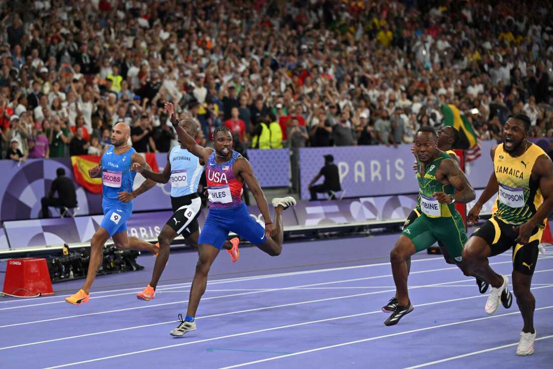 Lyles crosses the finish line ahead of Jamaica's Kishane Thompson in the men's 100m final on Sunday night at Stade de France in Saint-Denis, north of Paris.