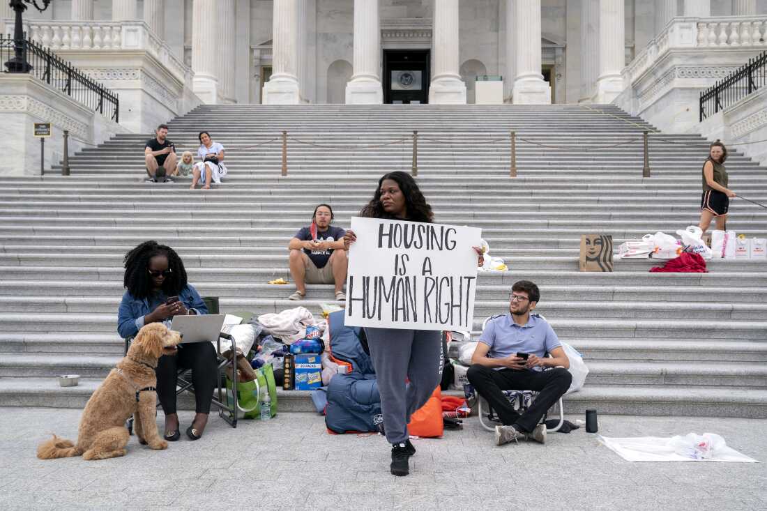 Rep. Cori Bush, a Democrat from Missouri, center, joined by congressional staffers and activists, protests the expiration of the eviction moratorium outside of the U.S. Capitol in Washington, D.C. on July 31, 2021. 