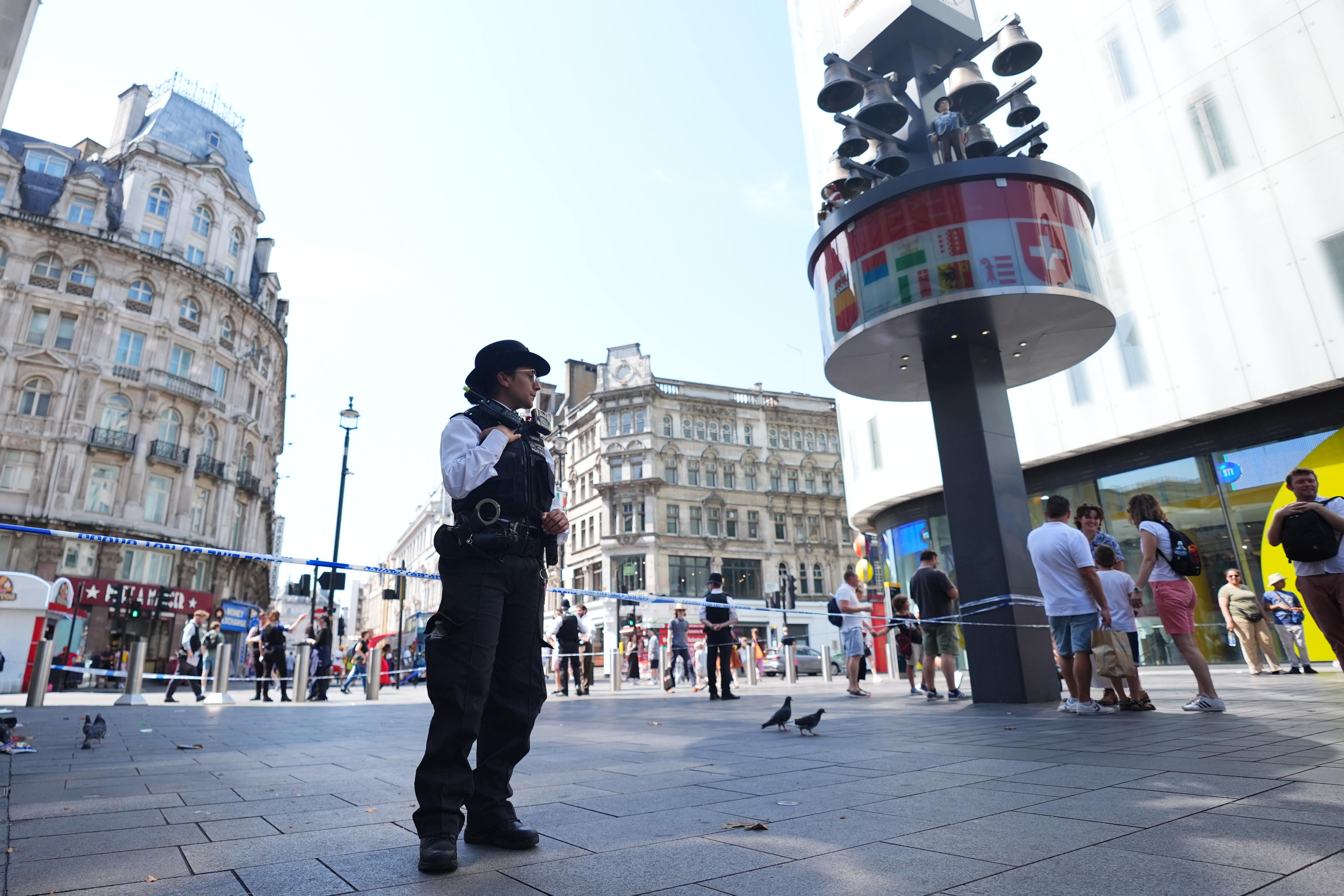 Police officers at the scene in Leicester Square in central London