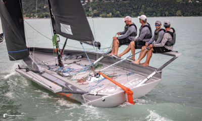 Sailors leaning over the side on the water