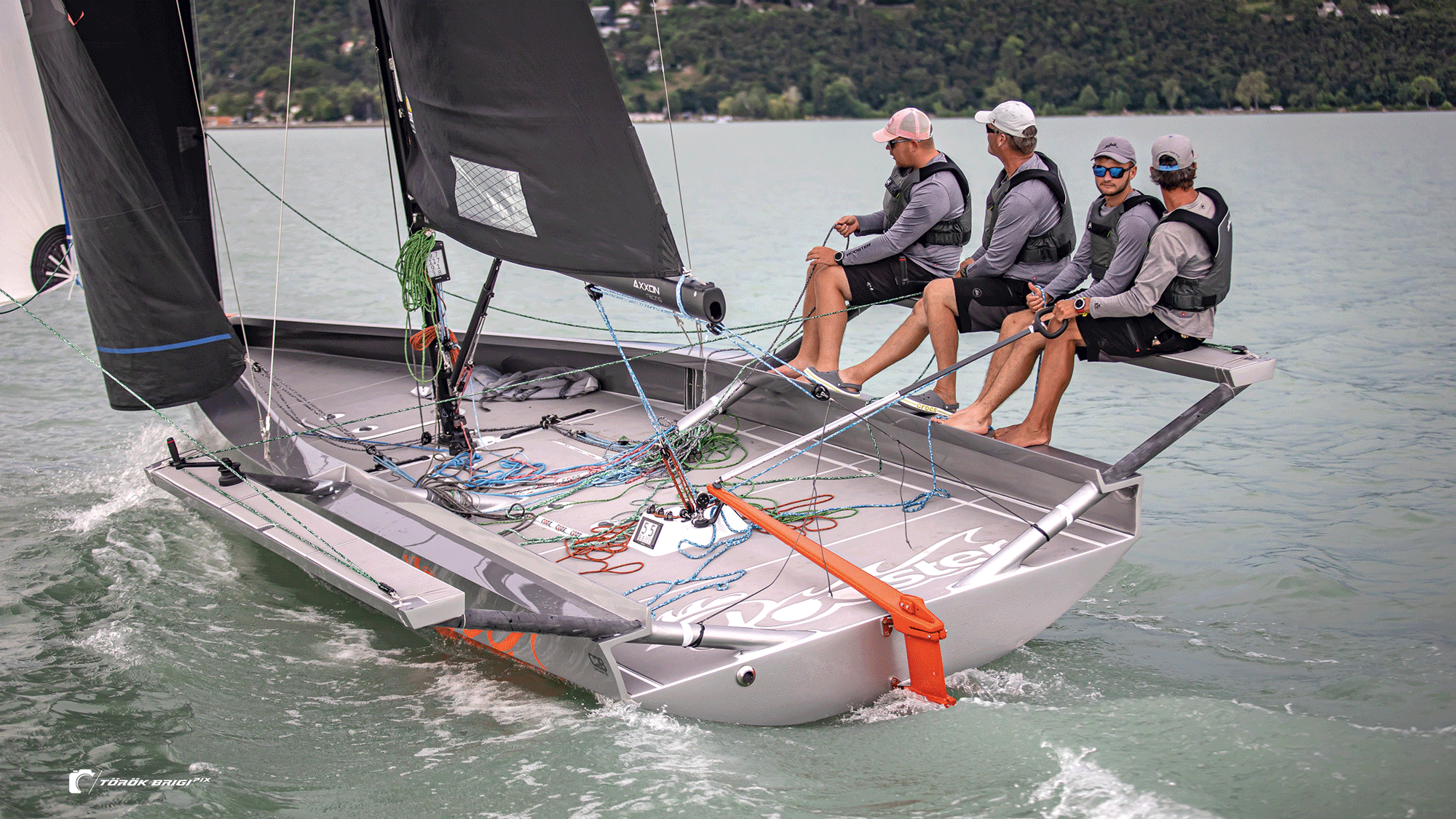 Sailors leaning over the side on the water