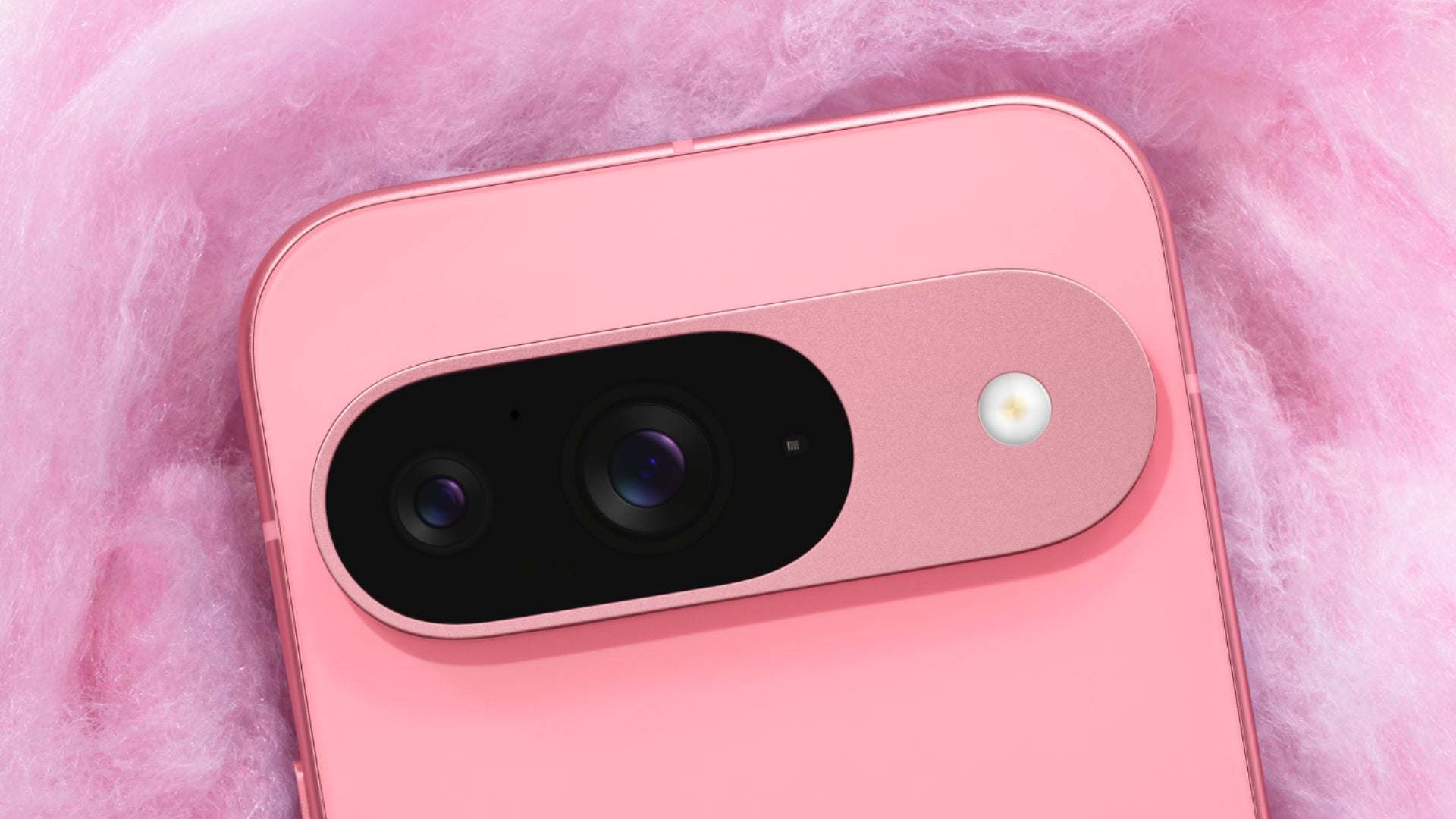 Close up of the Google Pixel 9's camera bar, sitting on a fluffy pink backdrop