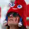 A Canada fan dons an Olympic mascot Phryge hat before the women's quarter-final football match between Canada and Germany during the Paris Olympics.