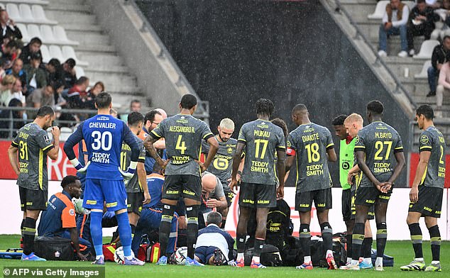 Concerned Lille players gathered around their team-mate as he received medical treatment