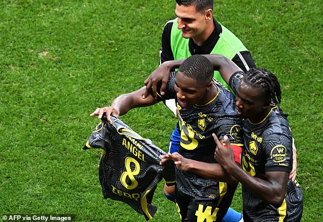 Bafode Diakite pictured celebrating his goal by holding up the shirt of team-mate Gomes