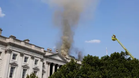 Reuters Smoke rises as firefighters work at the scene of a fire at Somerset House in London